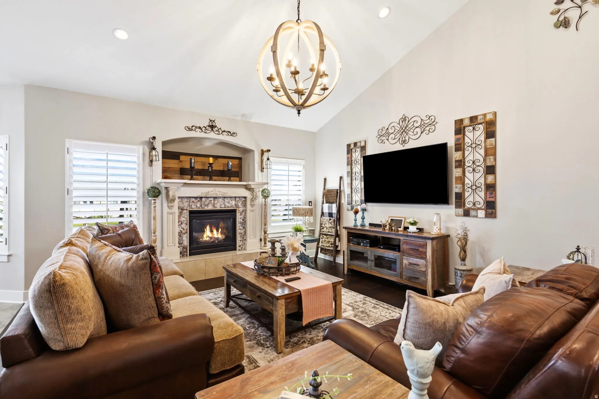 Vaulted ceiling with recessed lighting and a decorative orb chandelier