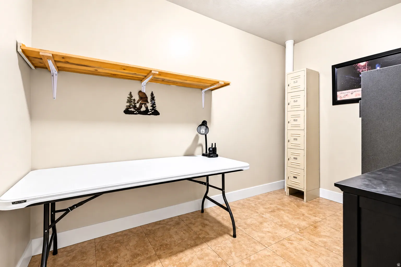 Built-in overhead shelving, permanent storage locker unit, tiled flooring, painted walls