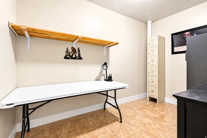 Built-in overhead shelving, permanent storage locker unit, tiled flooring, painted walls