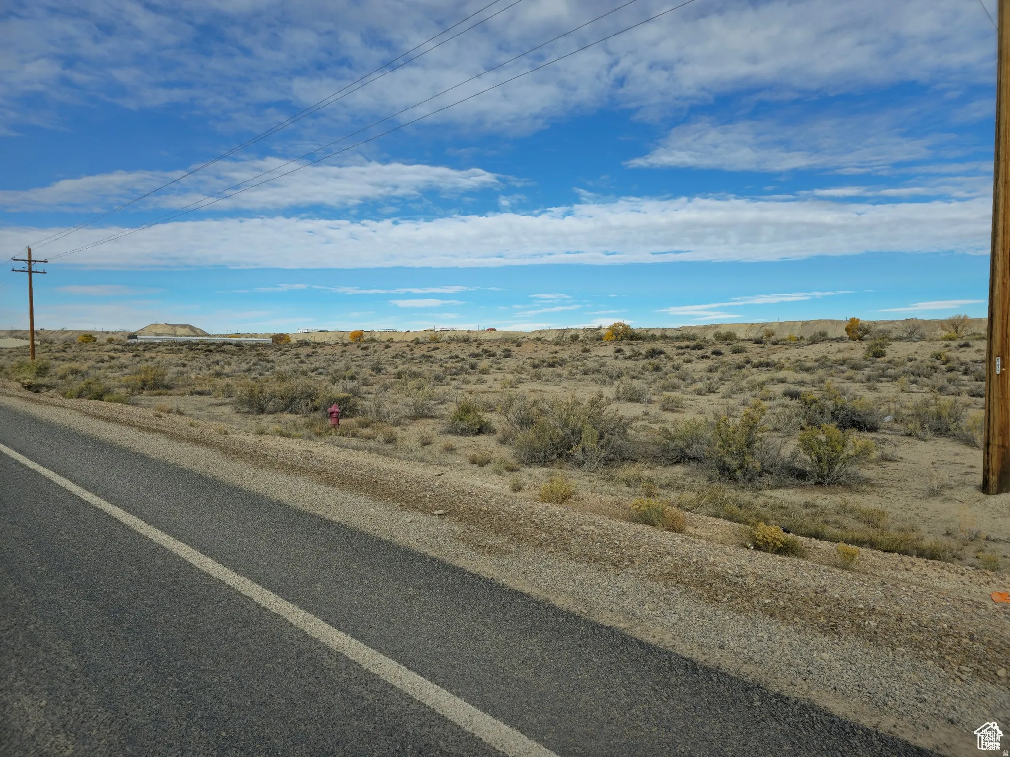 Expansive desert landscape with scattered low-lying vegetation