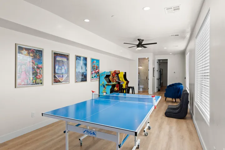 Recessed lighting, wood-finish flooring, ceiling fan, multiple windows with blinds, and a built-in doorway