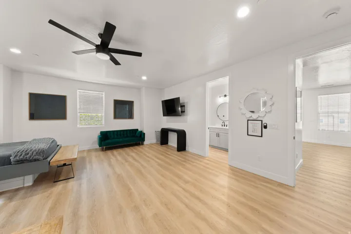 Recessed lighting, wood-finish flooring, and a contemporary ceiling fan