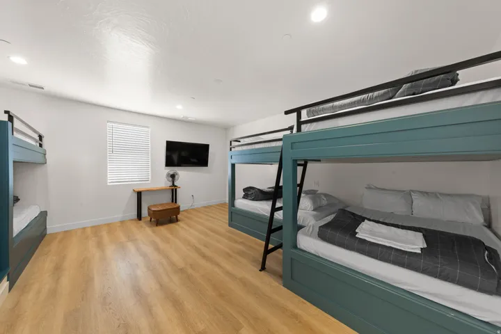 Wood-finish flooring with white walls and recessed lighting