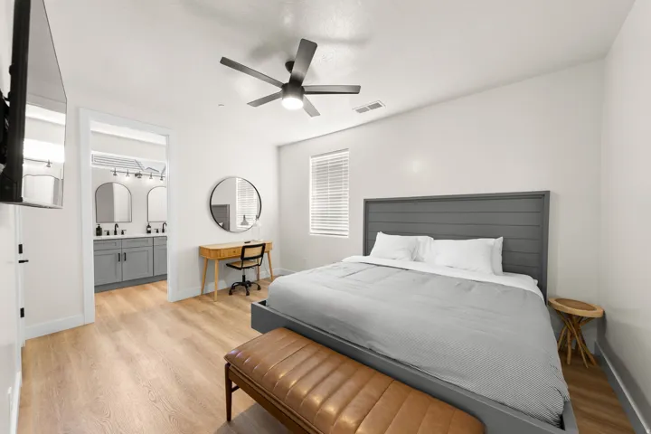 Wood-finish flooring throughout, with a ceiling fan featuring integrated lighting