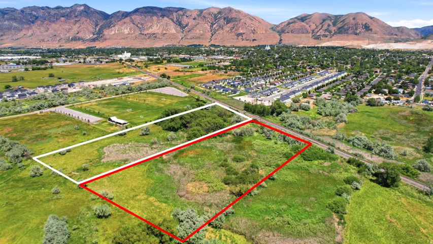 Expansive land parcel featuring natural vegetation and mountain backdrop
