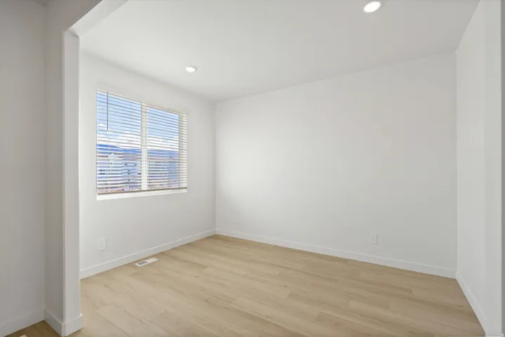 **DISCLAIMER** Interior package may vary. Recessed lighting, light wood-finish flooring, white walls, and a window with horizontal blinds