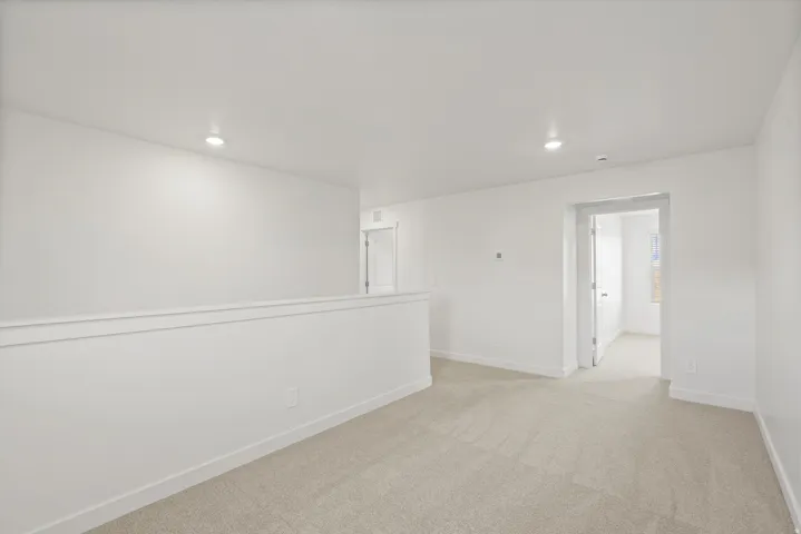 **DISCLAIMER** Interior package may vary. Neutral-toned carpeting, recessed lighting, white walls, and white trim molding