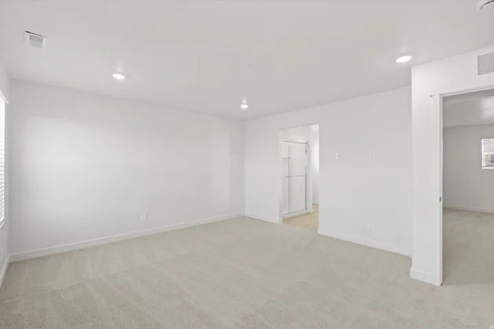 **DISCLAIMER** Interior package may vary. Recessed lighting illuminates the room, featuring light-colored carpeting, white walls, and white trim