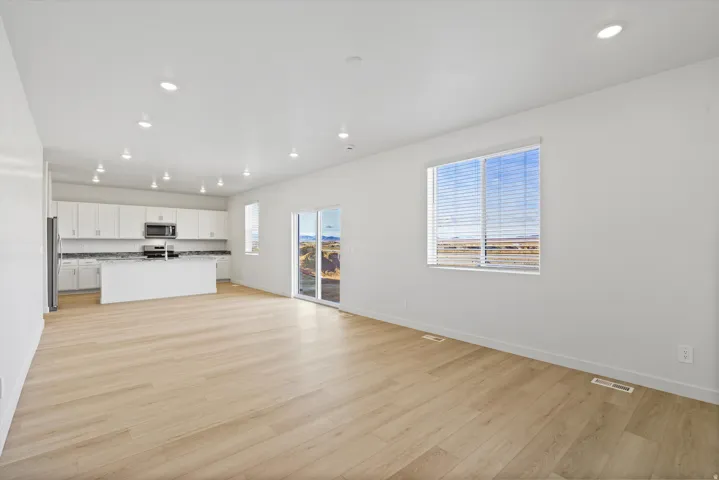 **DISCLAIMER** Interior package may vary. Open-concept living space with wood-finish flooring, recessed lighting, and white walls