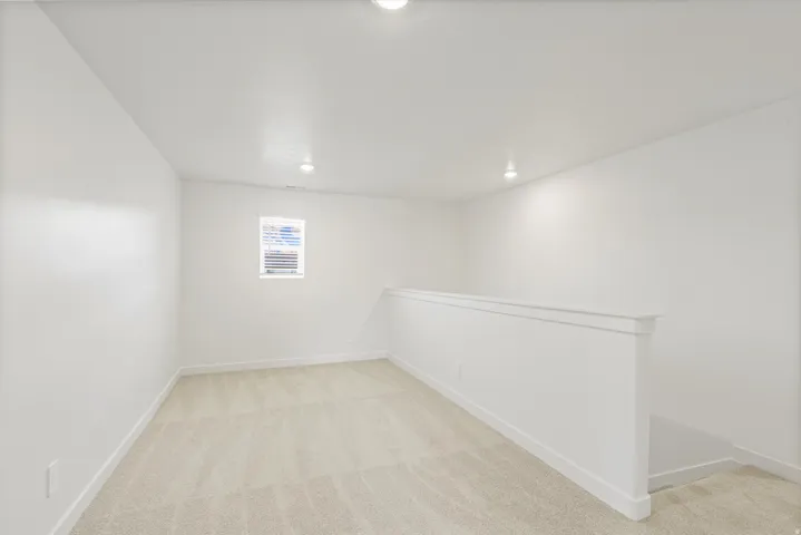 **DISCLAIMER** Interior package may vary. Neutral-toned carpeting, white walls, recessed ceiling lighting, and a white window frame with blinds