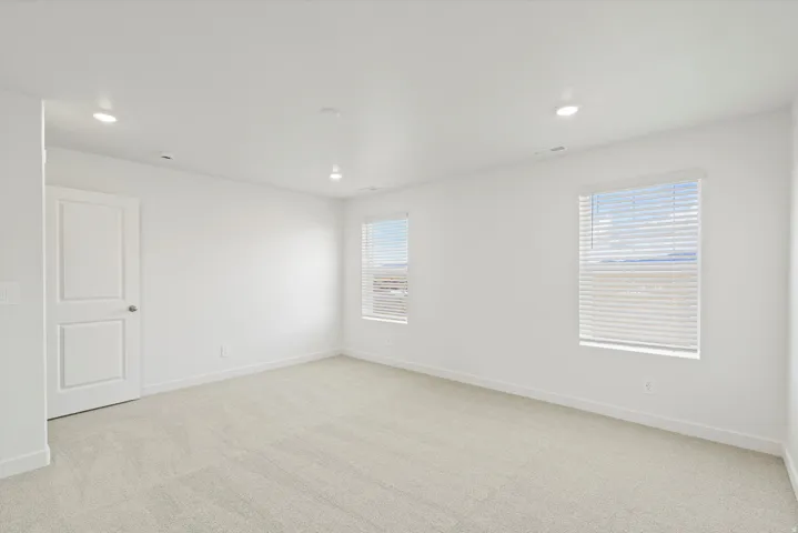 **DISCLAIMER** Interior package may vary. Plush neutral-toned carpeting, recessed ceiling lighting, two windows with blinds, and white interior door