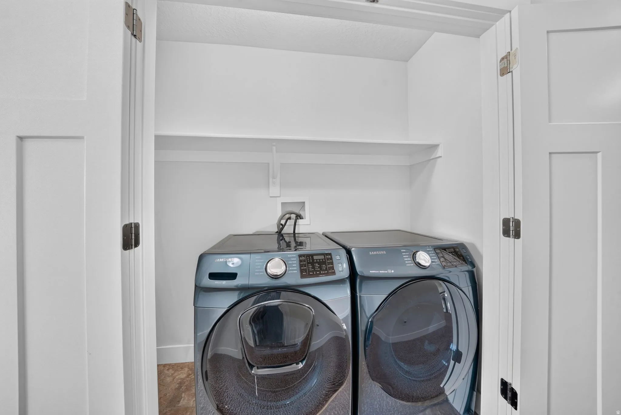 Dedicated laundry area with a built-in shelf
