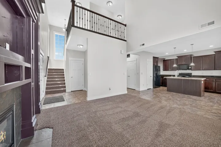 Open-concept layout with high ceilings and a second-story landing