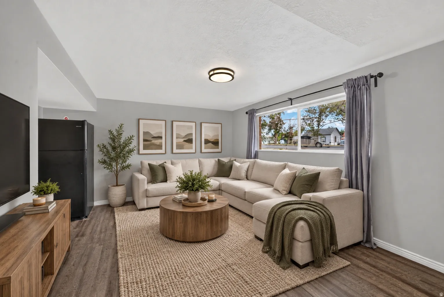 Virtually Staged Image. Wood-finish flooring, light grey wall paint, and a built-in window