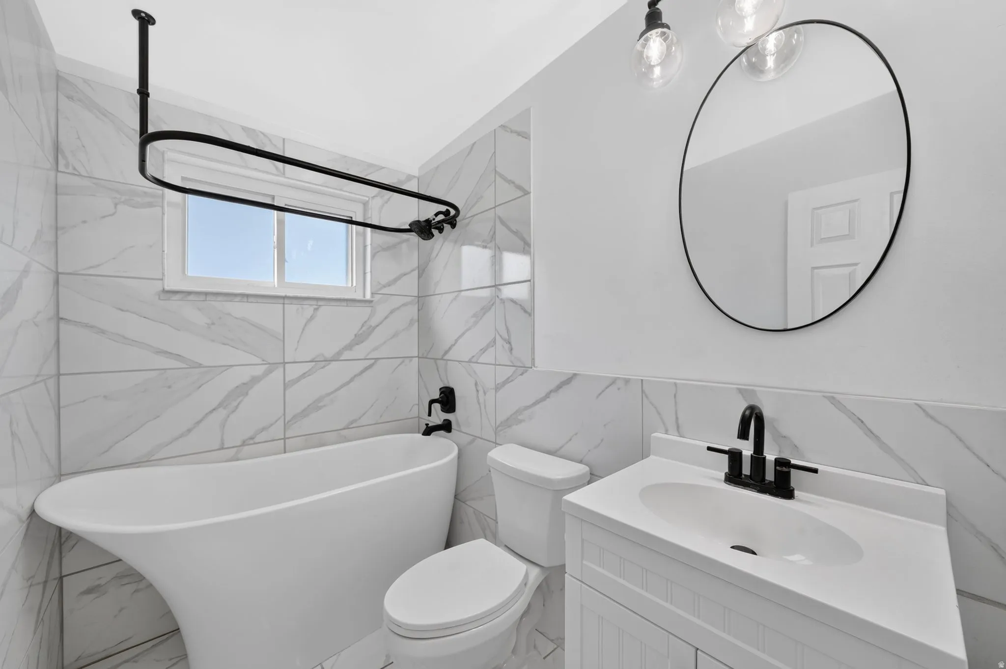 Freestanding soaking tub with matte black fixtures