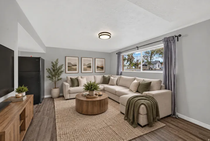 Virtually Staged Image. Wood-finish flooring, light grey wall paint, and a built-in window
