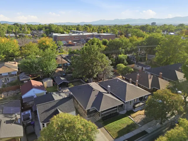 Neighborhood setting featuring mature trees and mountain scenery
