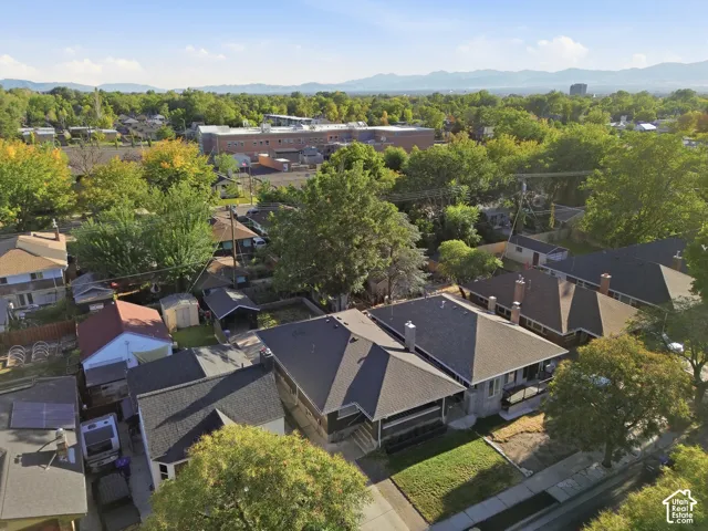 Neighborhood setting featuring mature trees and mountain scenery