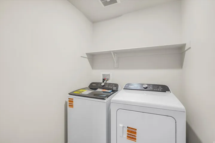 Laundry area featuring a wall-mounted shelf