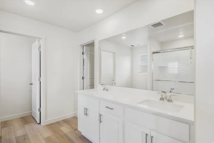 Dual vanity with white cabinetry and integrated sinks