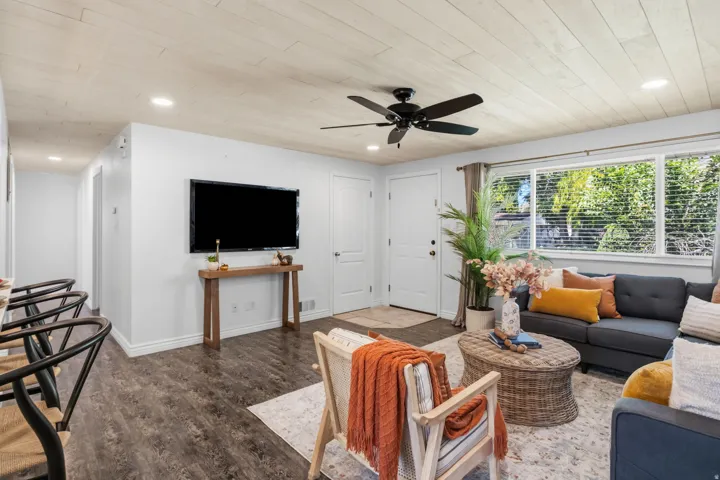 Wood-finish flooring throughout, complemented by a light wood-paneled ceiling