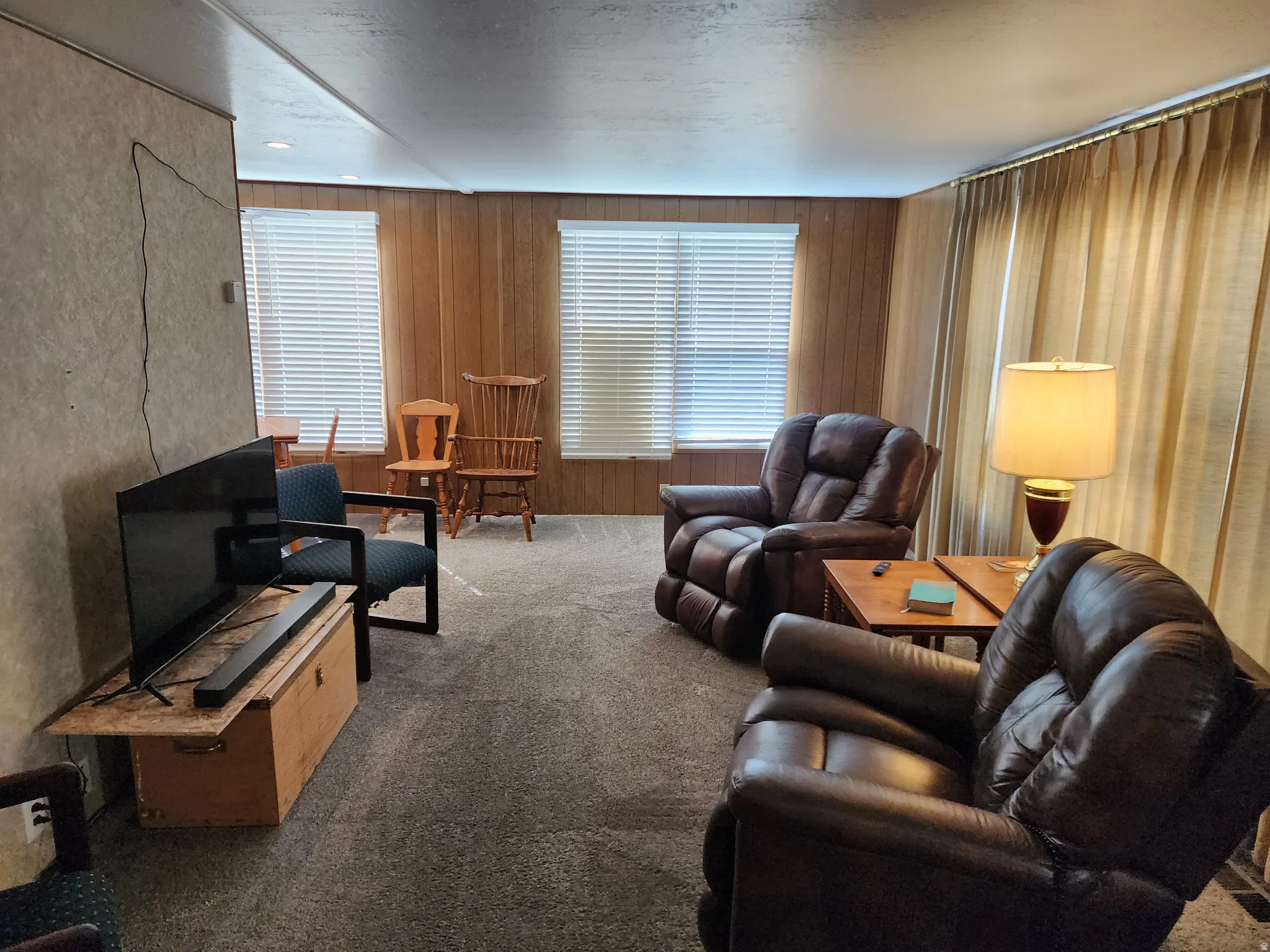 Carpeted flooring, paneled wall accents, white window blinds, and recessed lighting