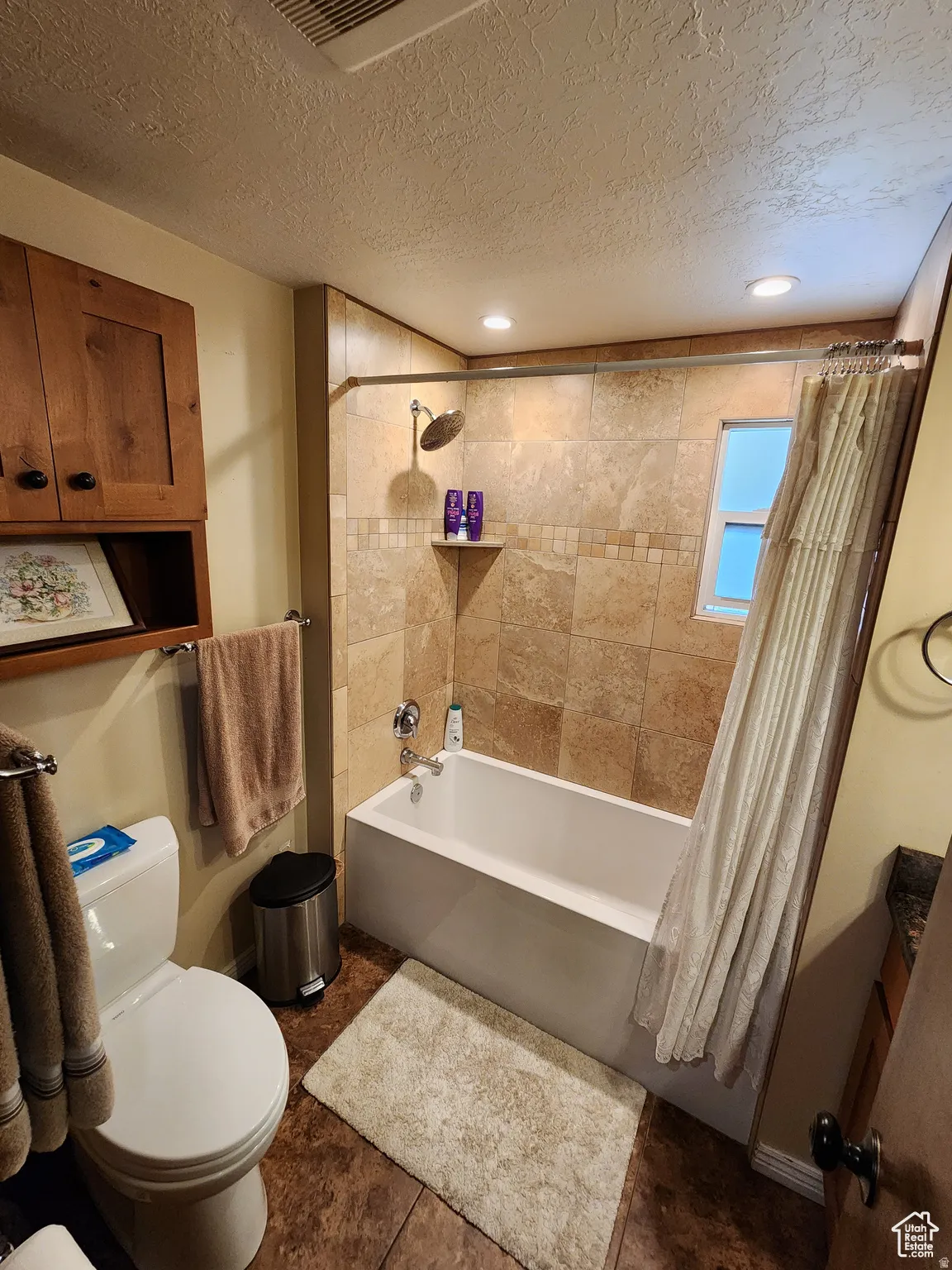 Tiled shower surround with integrated shower head and tub filler