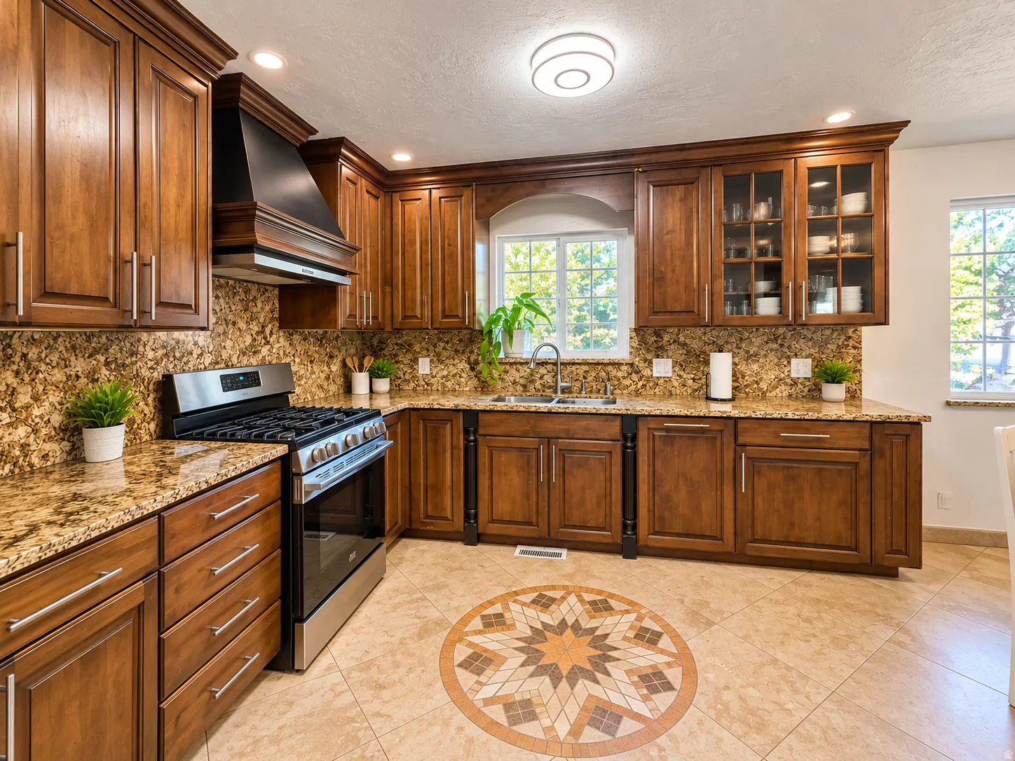 Wood cabinetry, granite countertops, tile flooring with an inlaid pattern, stainless steel range, and built-in glass display cabinets