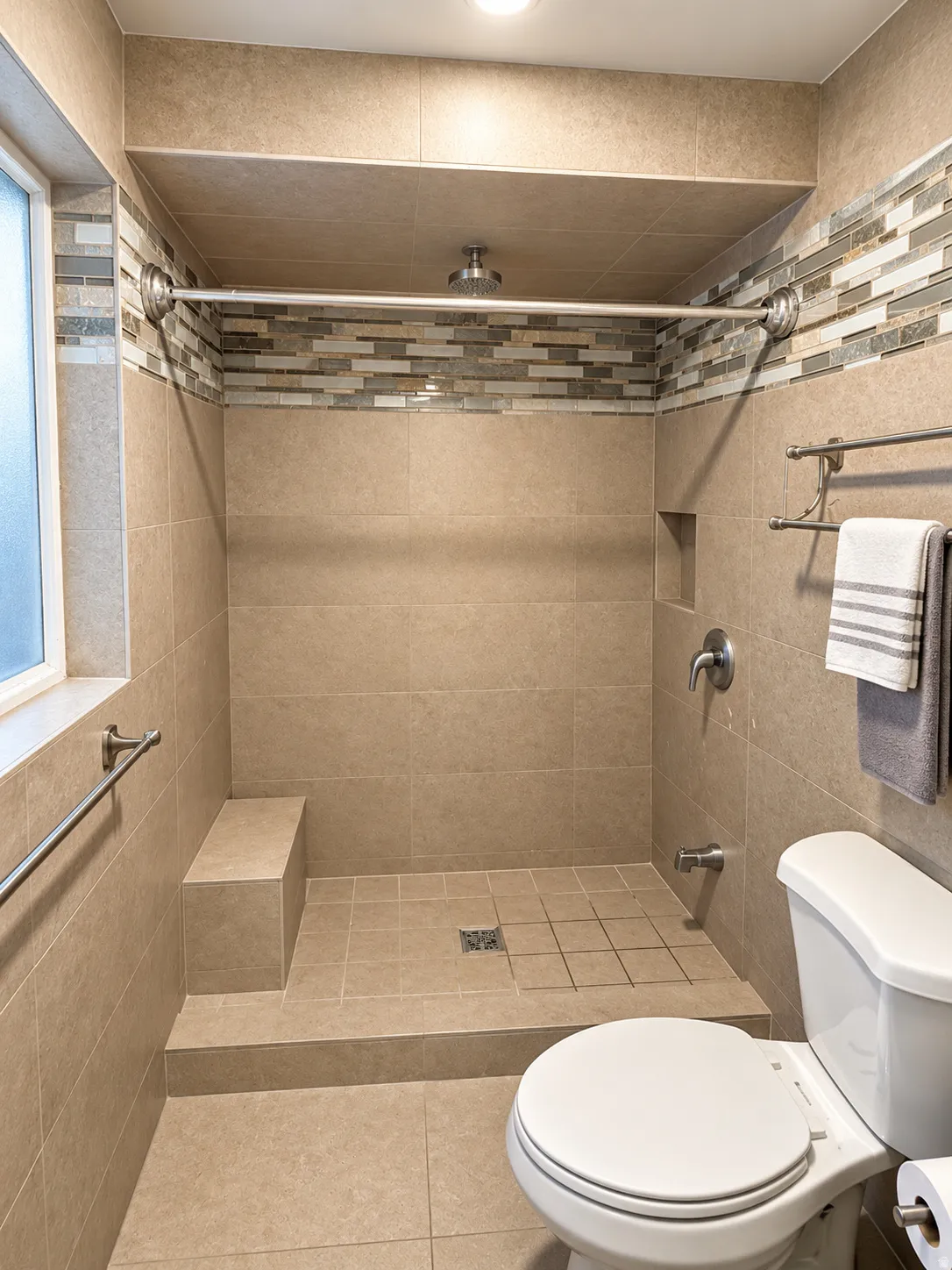 Bathroom 2, Tiled shower with a built-in bench, recessed shelf, and mosaic accent tile