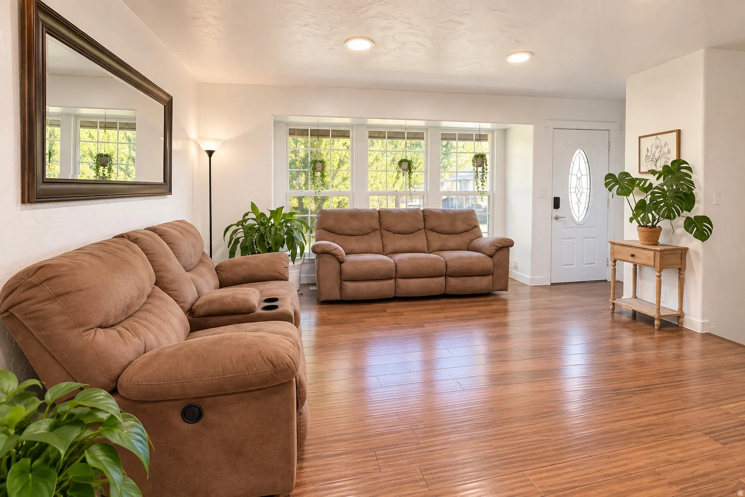 Wood-finish flooring, recessed lighting, and a front entry door with an oval glass insert