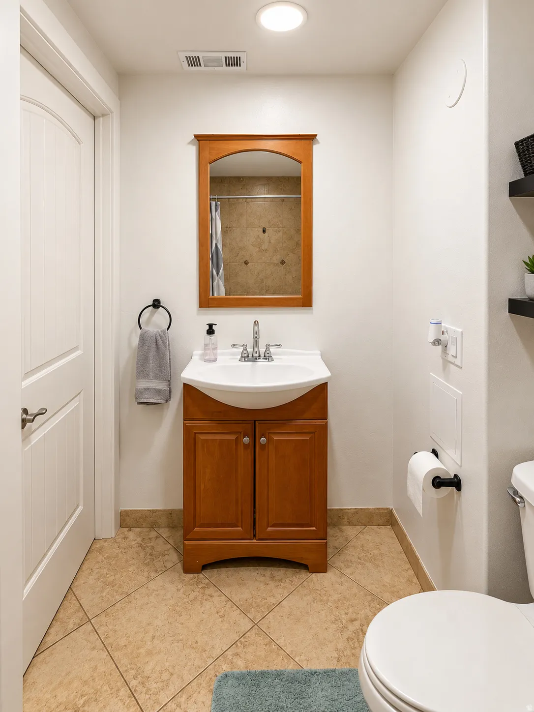 Bathroom featuring a wooden vanity with a white sink, tiled flooring, recessed lighting, and a white paneled door