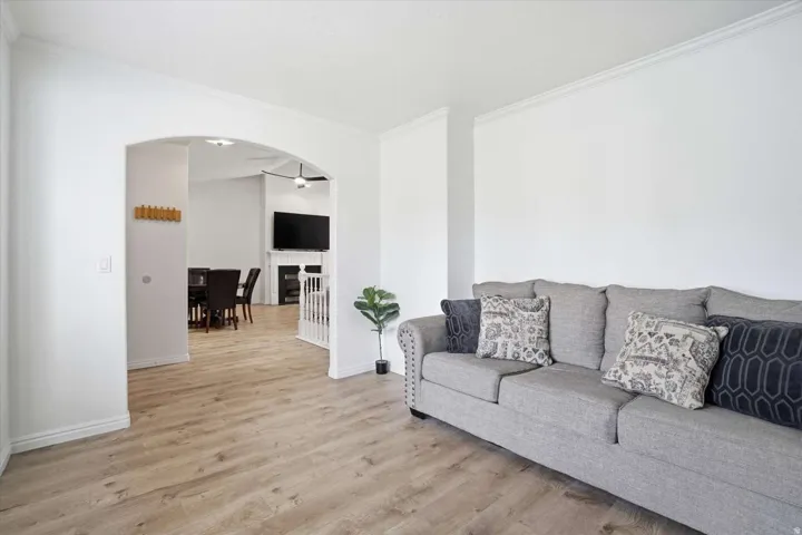 Light wood-finish flooring throughout, complemented by crisp white walls and crown molding