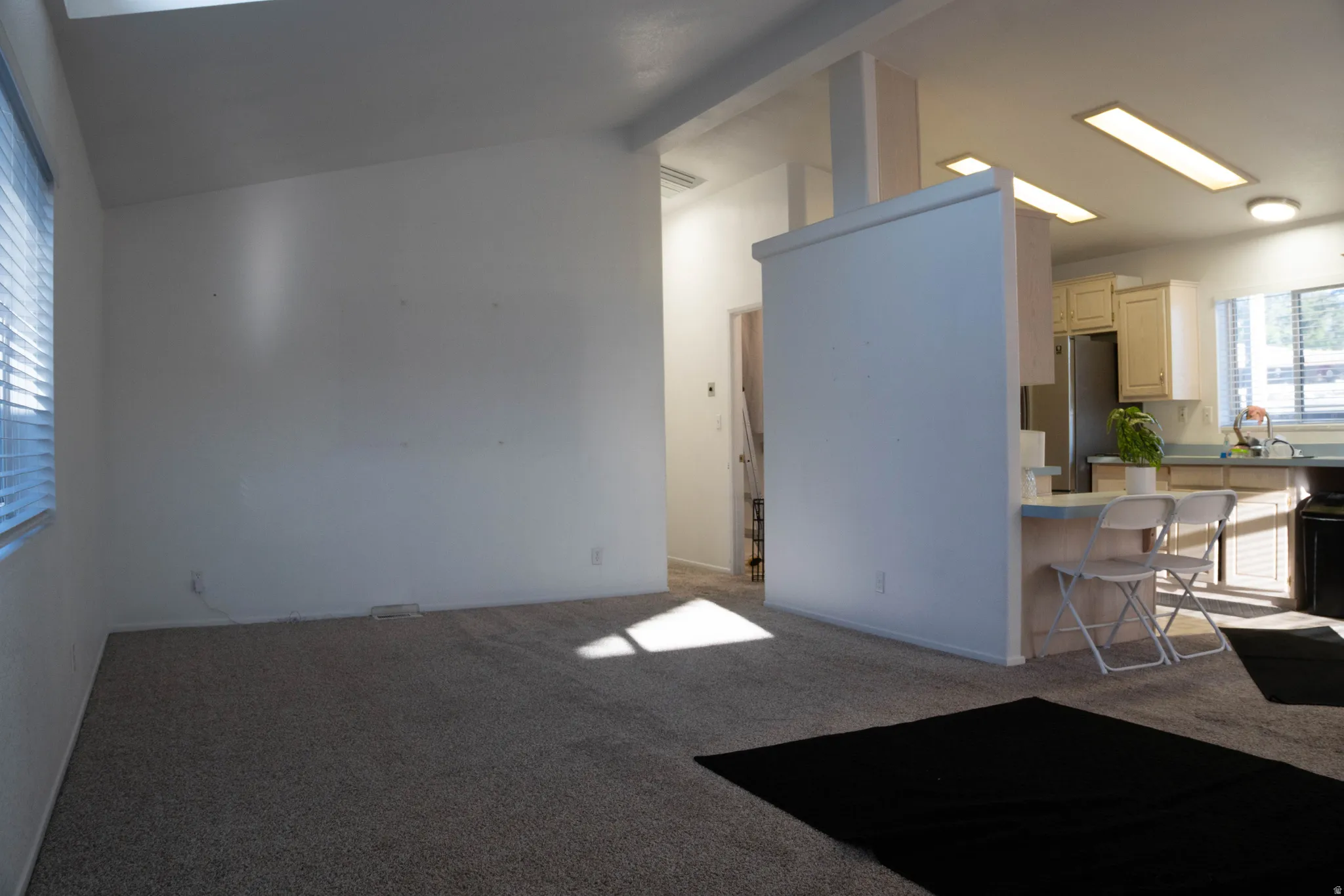 Vaulted ceiling with overhead lighting