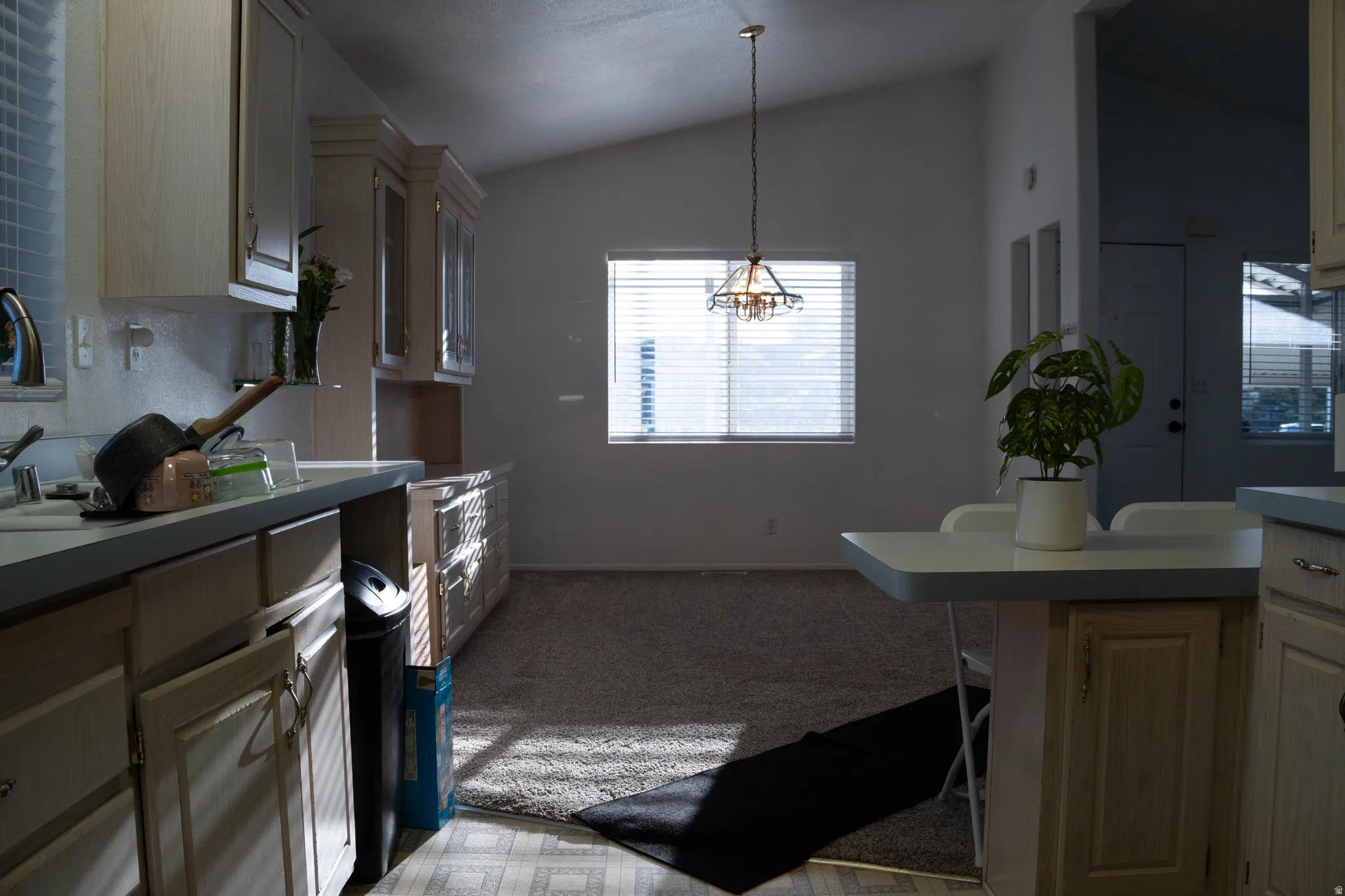 Kitchen featuring light-toned cabinetry, a built-in breakfast bar, and a single basin sink