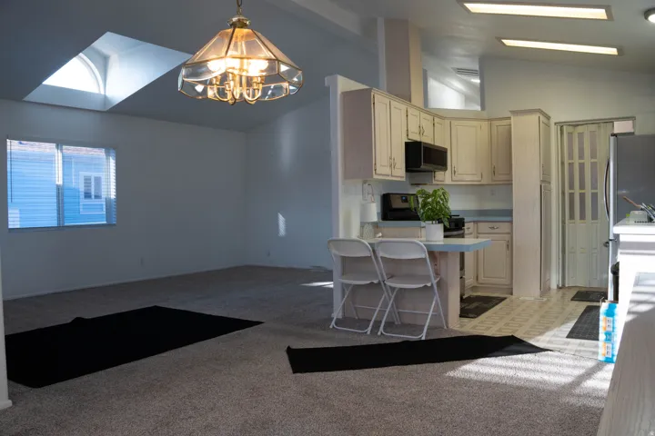 Vaulted ceilings, skylight, recessed lighting, built-in cabinetry, and tile flooring