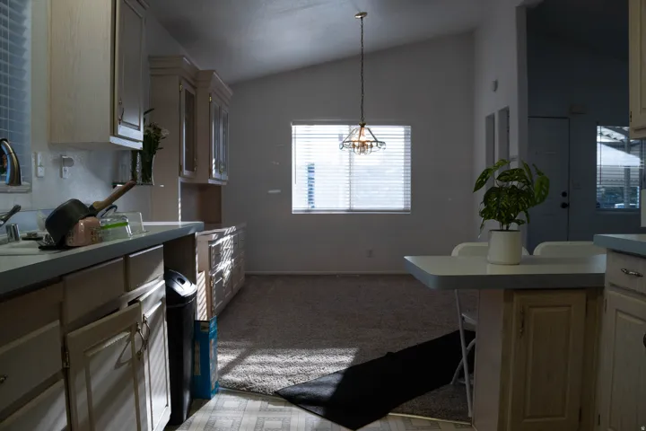Kitchen featuring light-toned cabinetry, a built-in breakfast bar, and a single basin sink