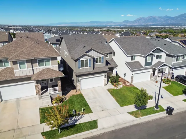 Modern dwelling with a two-car garage, manicured lawn, and paved driveway