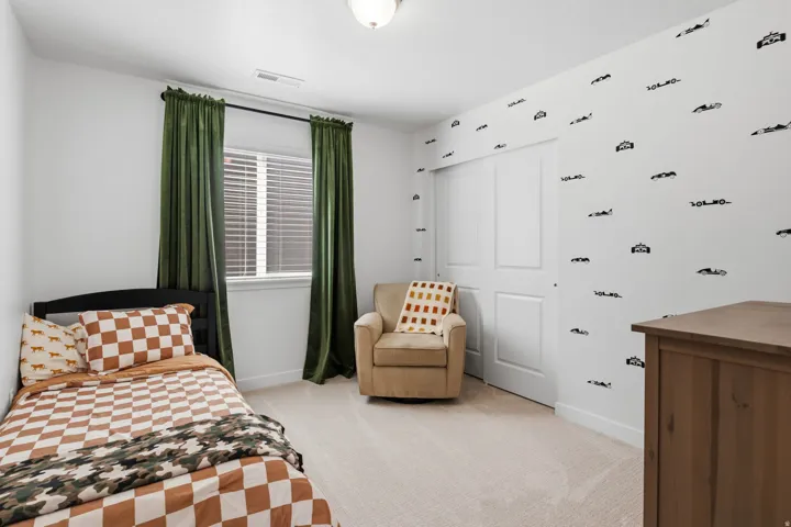 White walls, carpeted flooring, window with blinds, and white sliding closet doors