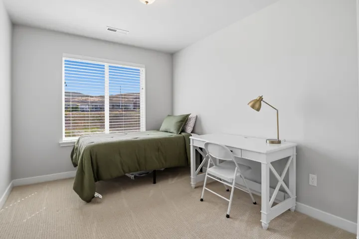 Window with horizontal blinds, neutral wall paint, and light-colored carpeting