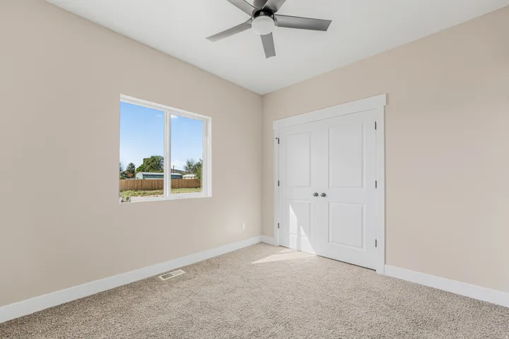 Recessed window, ceiling fan, neutral wall tones, carpeted flooring, and white trim