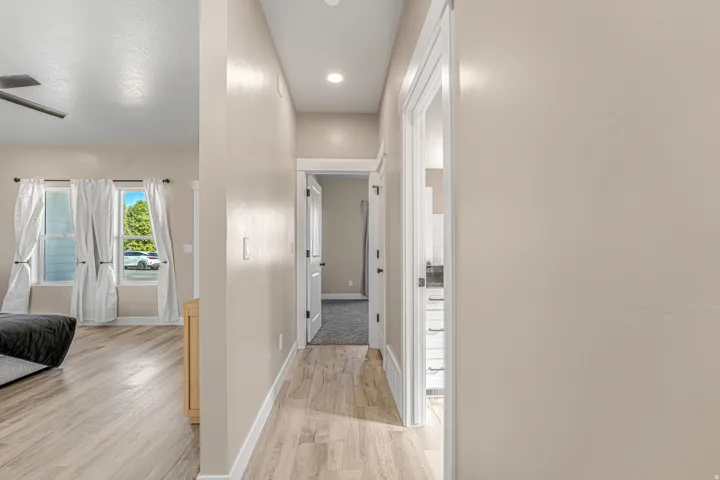 Wood-finish flooring throughout, recessed lighting, and white trim