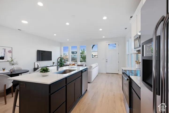 Open-concept living space with wood-finish flooring