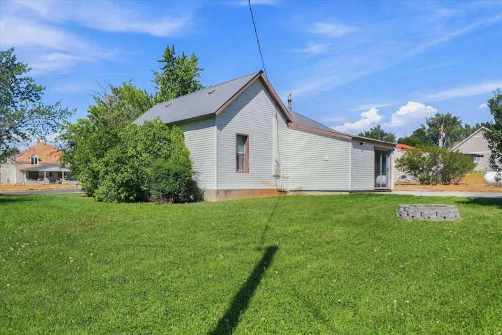 Expansive lawn with a metal roof on the main structure