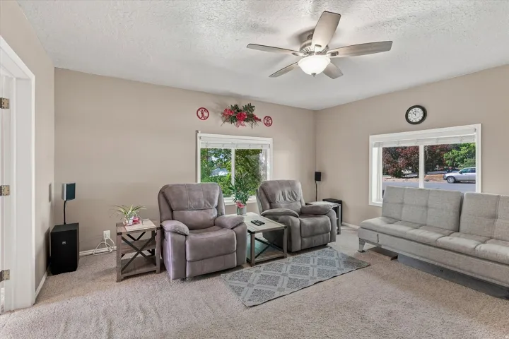 Neutral wall tones, recessed lighting, and a ceiling fan with integrated lighting