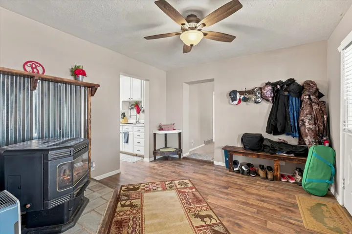 Wood-finish flooring throughout, complemented by a ceiling fan with integrated lighting