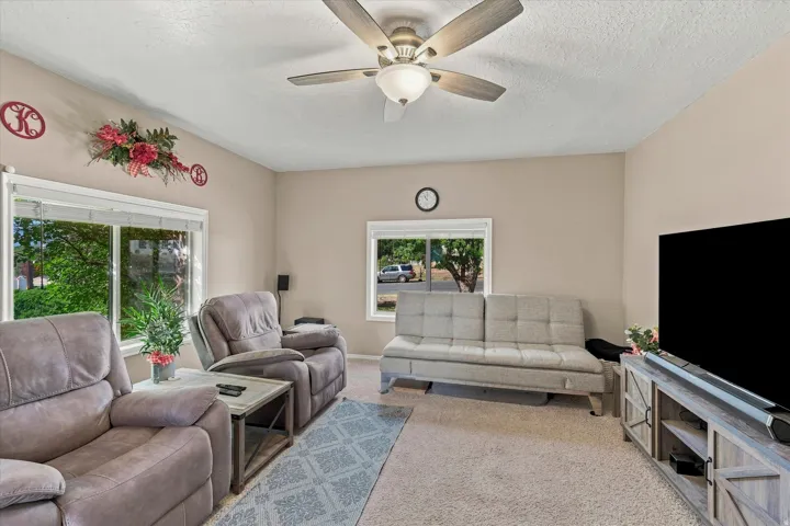 Recessed lighting, ceiling fan, and multiple windows with blinds