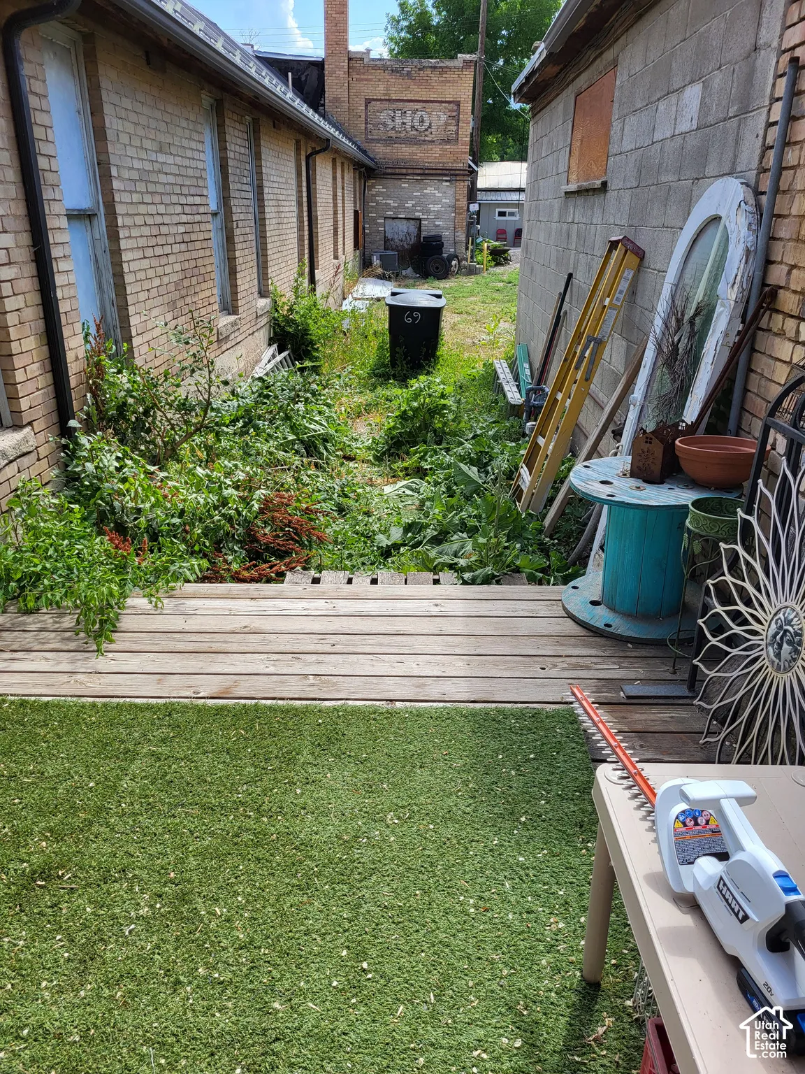 Exterior space featuring a timber deck and brick masonry building facades