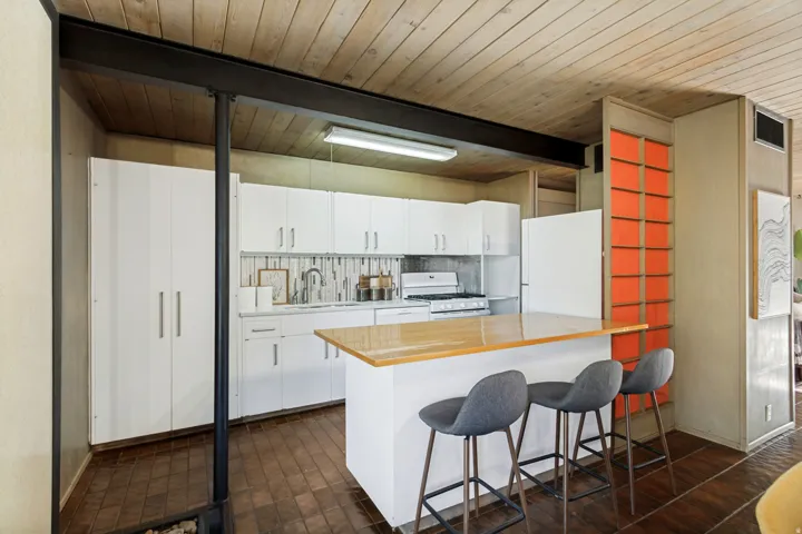 Kitchen featuring wood-finish ceiling, white cabinetry, wood-finish countertop on the island, and tile flooring
