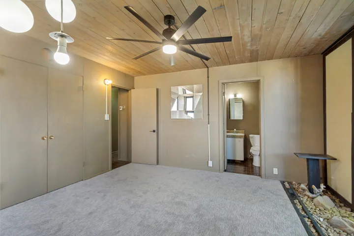 Wood-paneled ceiling with a ceiling fan
