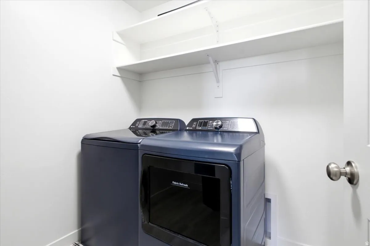 Laundry area with white walls and built-in shelving